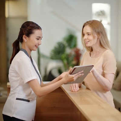 woman talking to receptionist at sempre spa