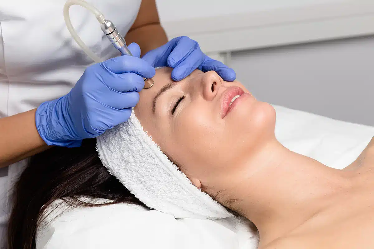 Beautiful woman getting facial microdermabrasion peeling treatment at luxury cosmetic beauty spa clinic