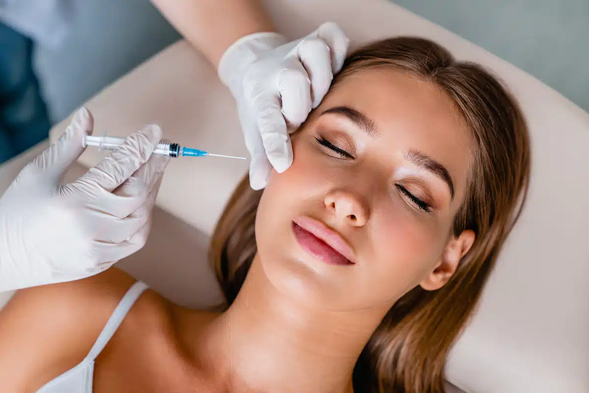 Young woman gets beauty facial injections